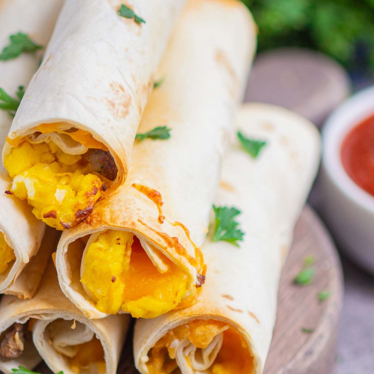 taquitos on a wooden serving board