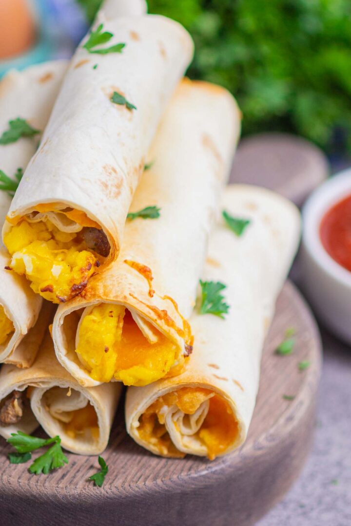 taquitos on a wooden serving board