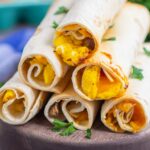 taquitos on a wooden serving board