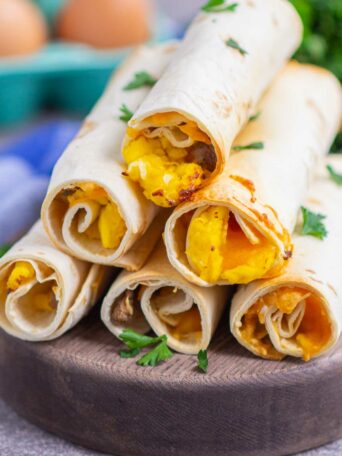 taquitos on a wooden serving board