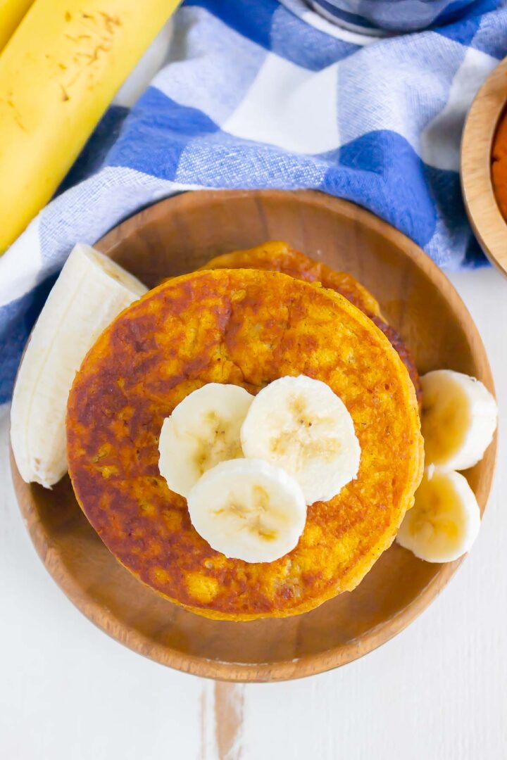 stack of pancakes on a wooden plate