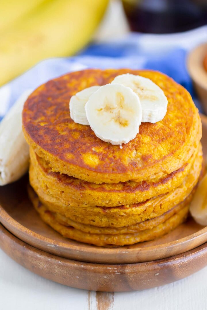 stack of pancakes on a wooden plate