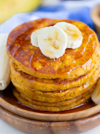 stack of pancakes on a wooden plate