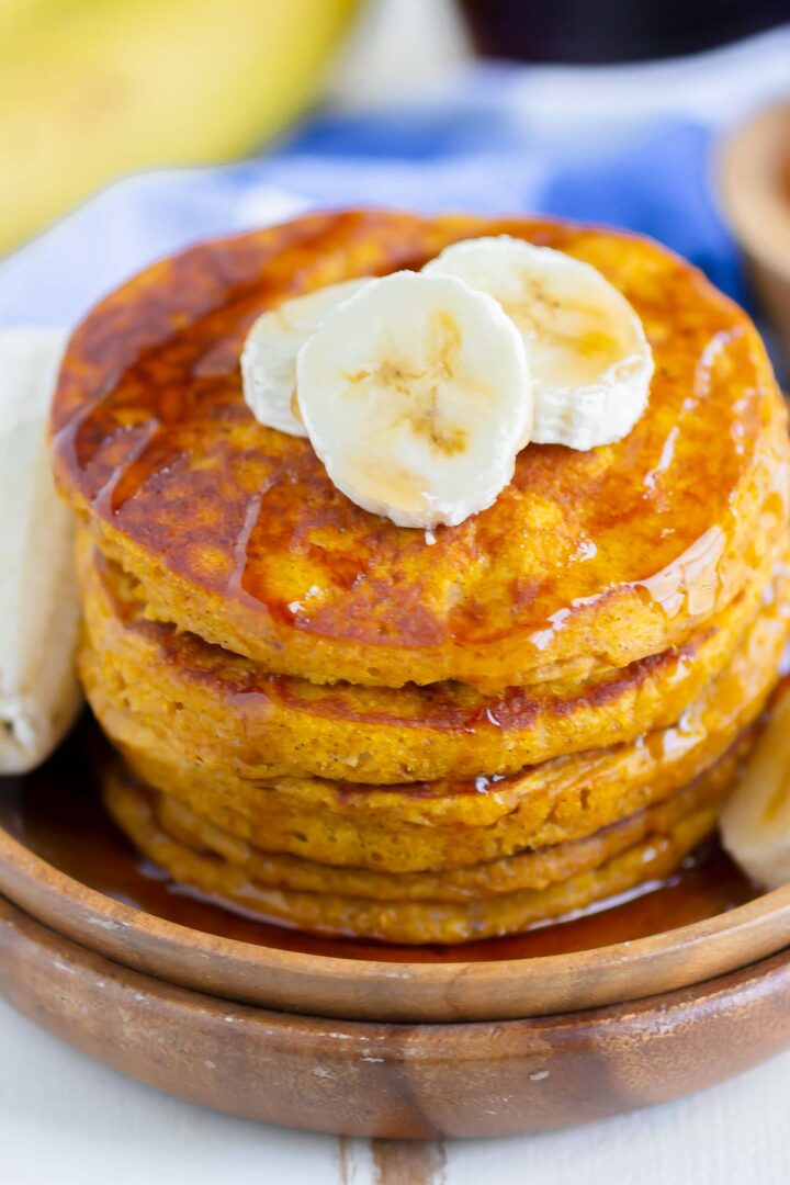 stack of pancakes on a wooden plate