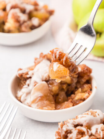 cinnamon roll bake in a white bowl with a fork