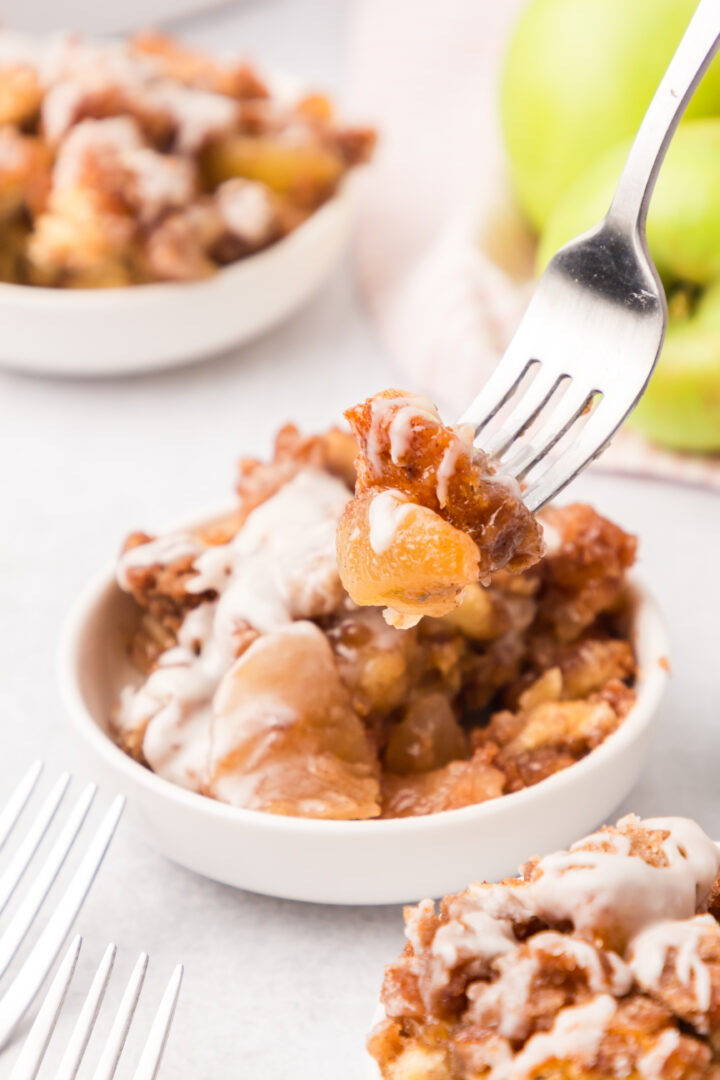 cinnamon roll bake in a white bowl with a fork