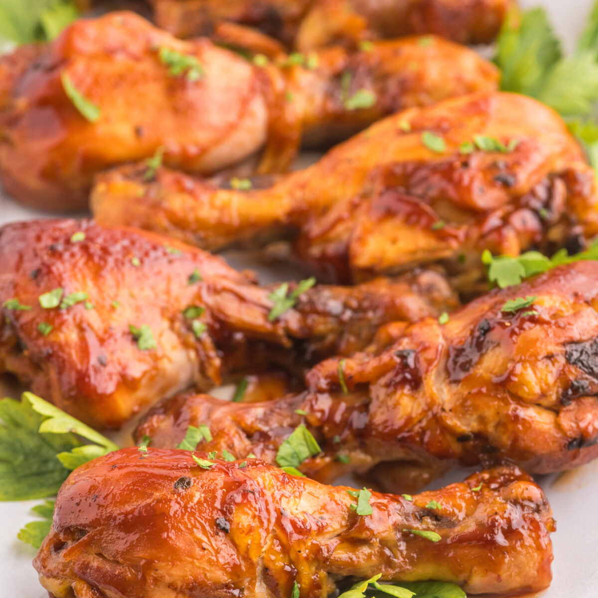 chicken legs on a white serving platter