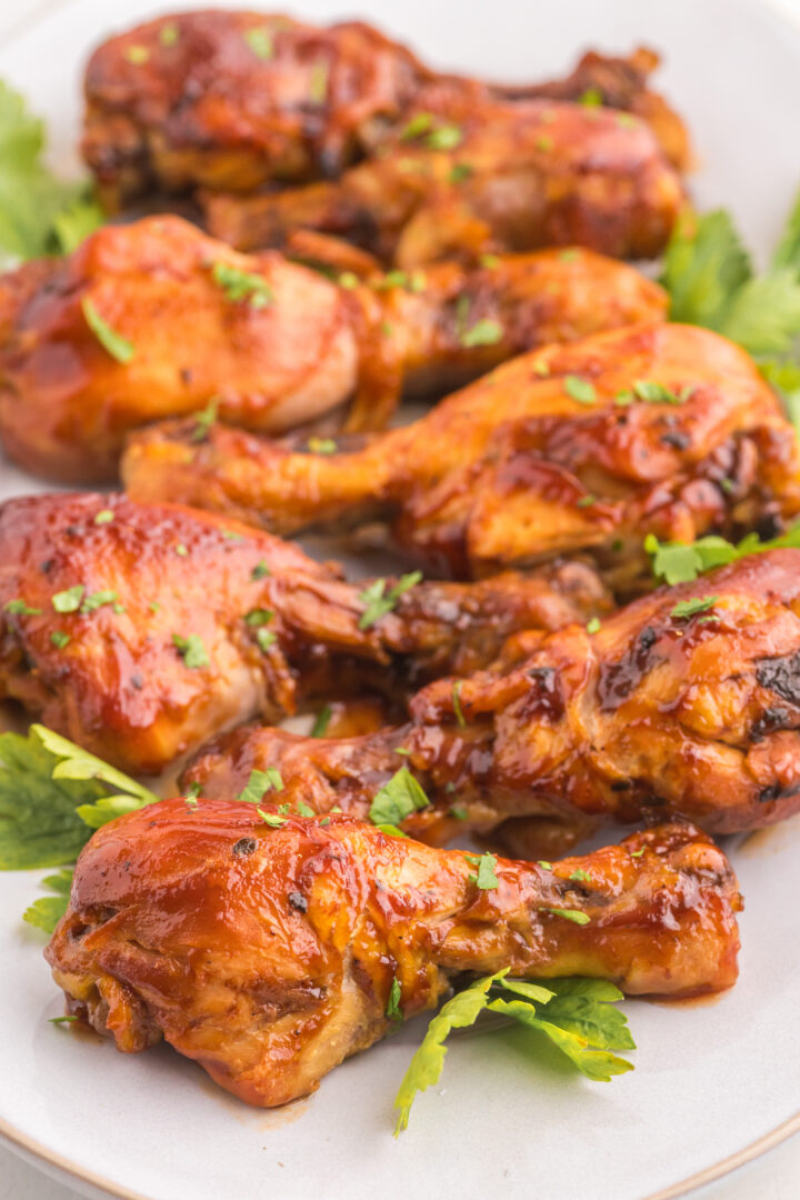 chicken legs on a white serving platter