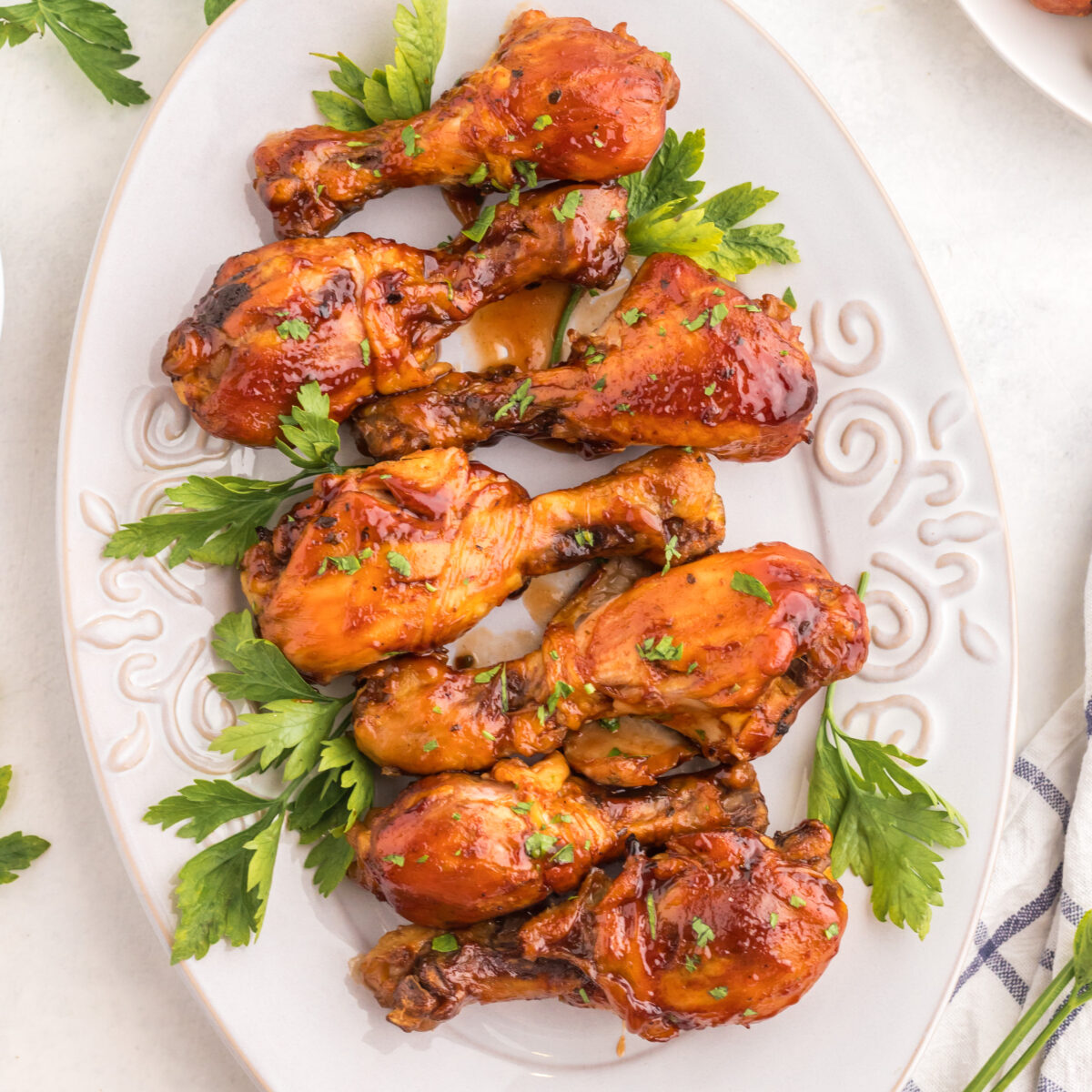 chicken legs on a white serving platter