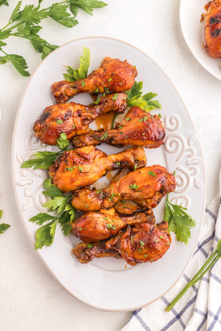 chicken legs on a white serving platter