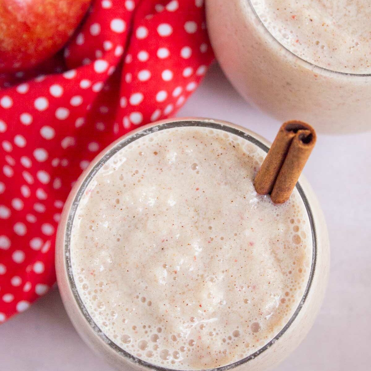 smoothie in a short glass with a cinnamon stick