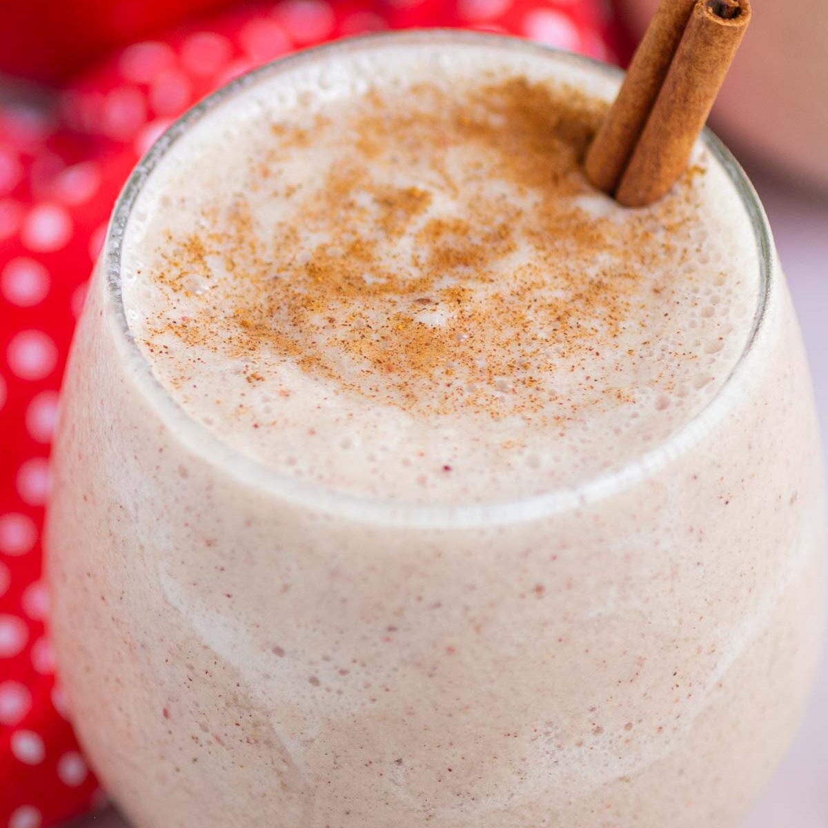 smoothie in a short glass with a cinnamon stick