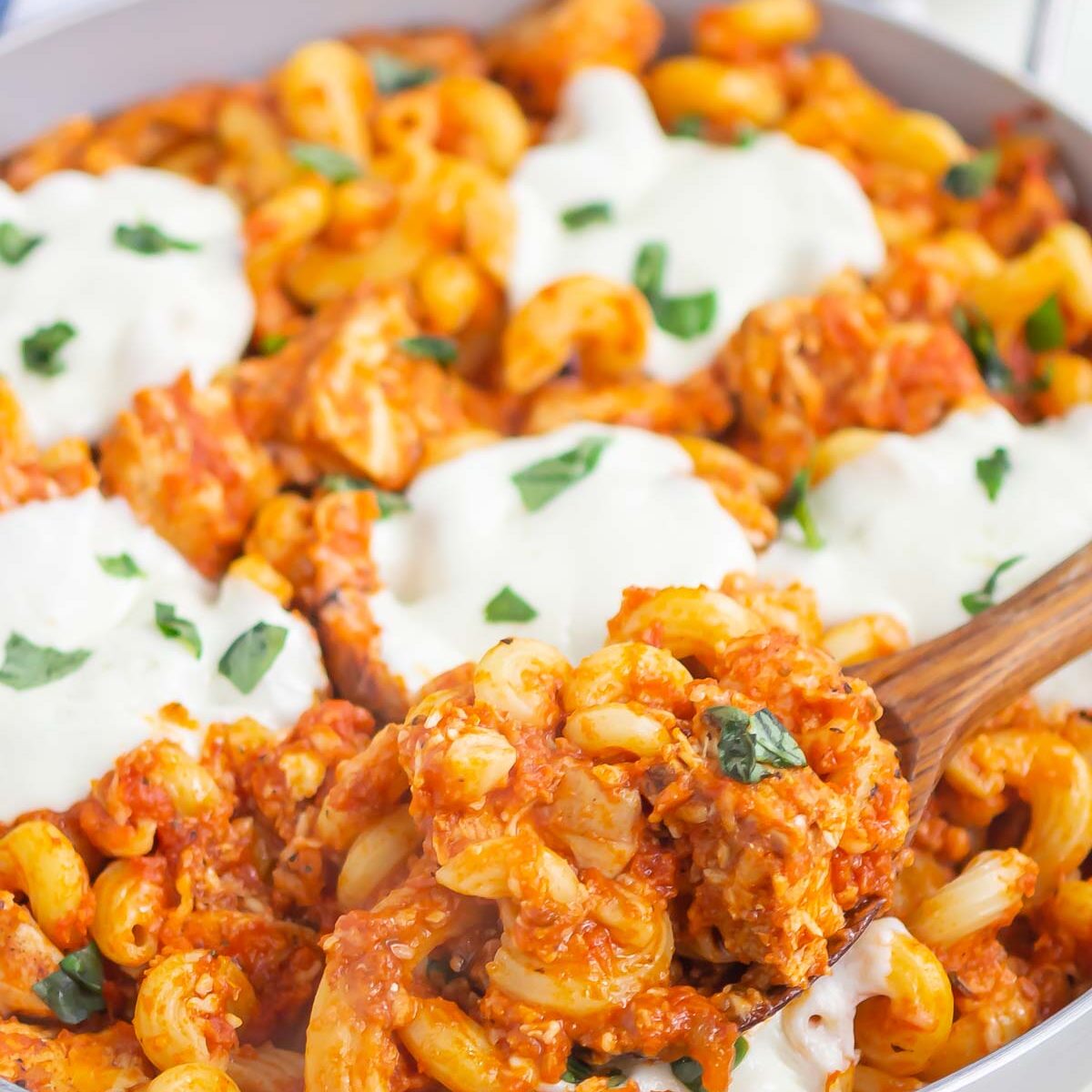 pasta in a skillet with a serving spoon