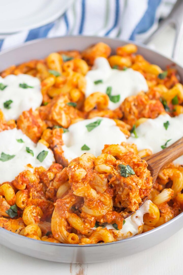 pasta in a skillet with a serving spoon