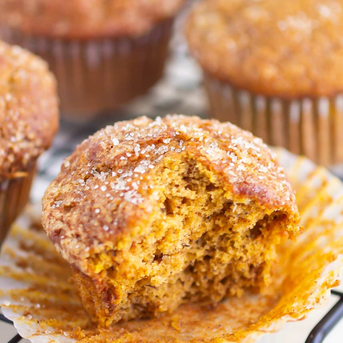 muffins on a wire rack with one muffin cut in half