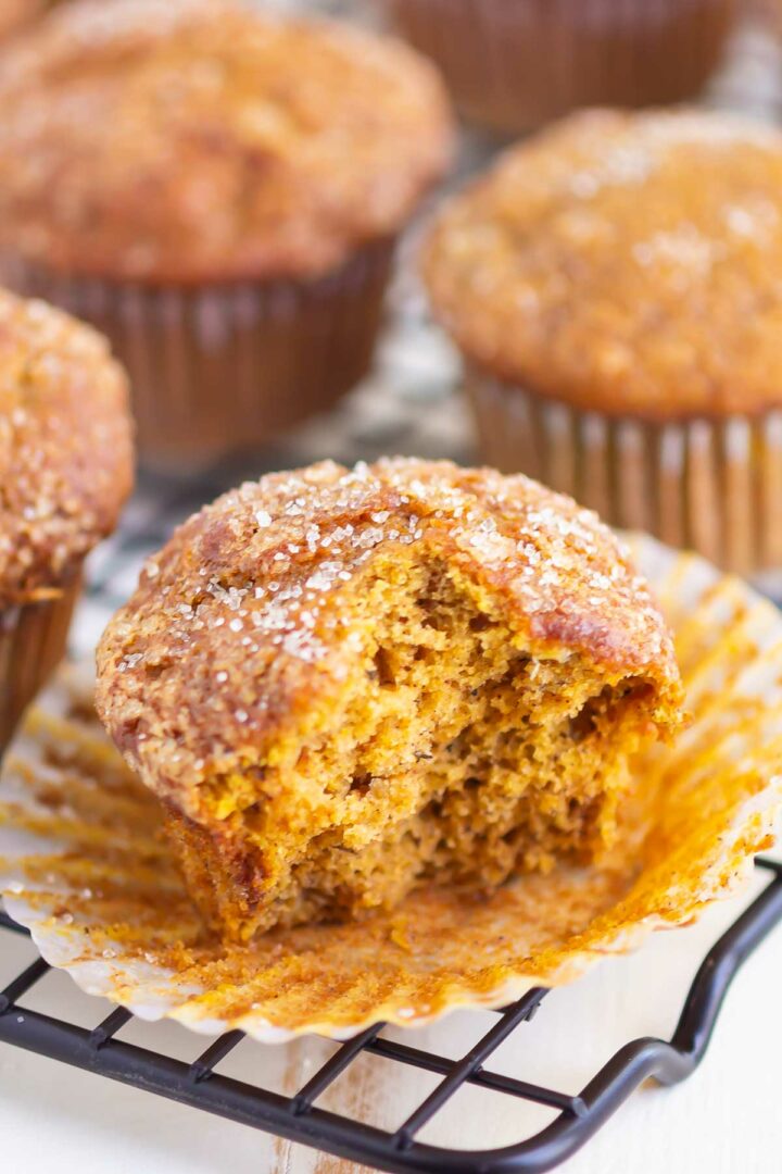 muffins on a wire rack with one muffin cut in half