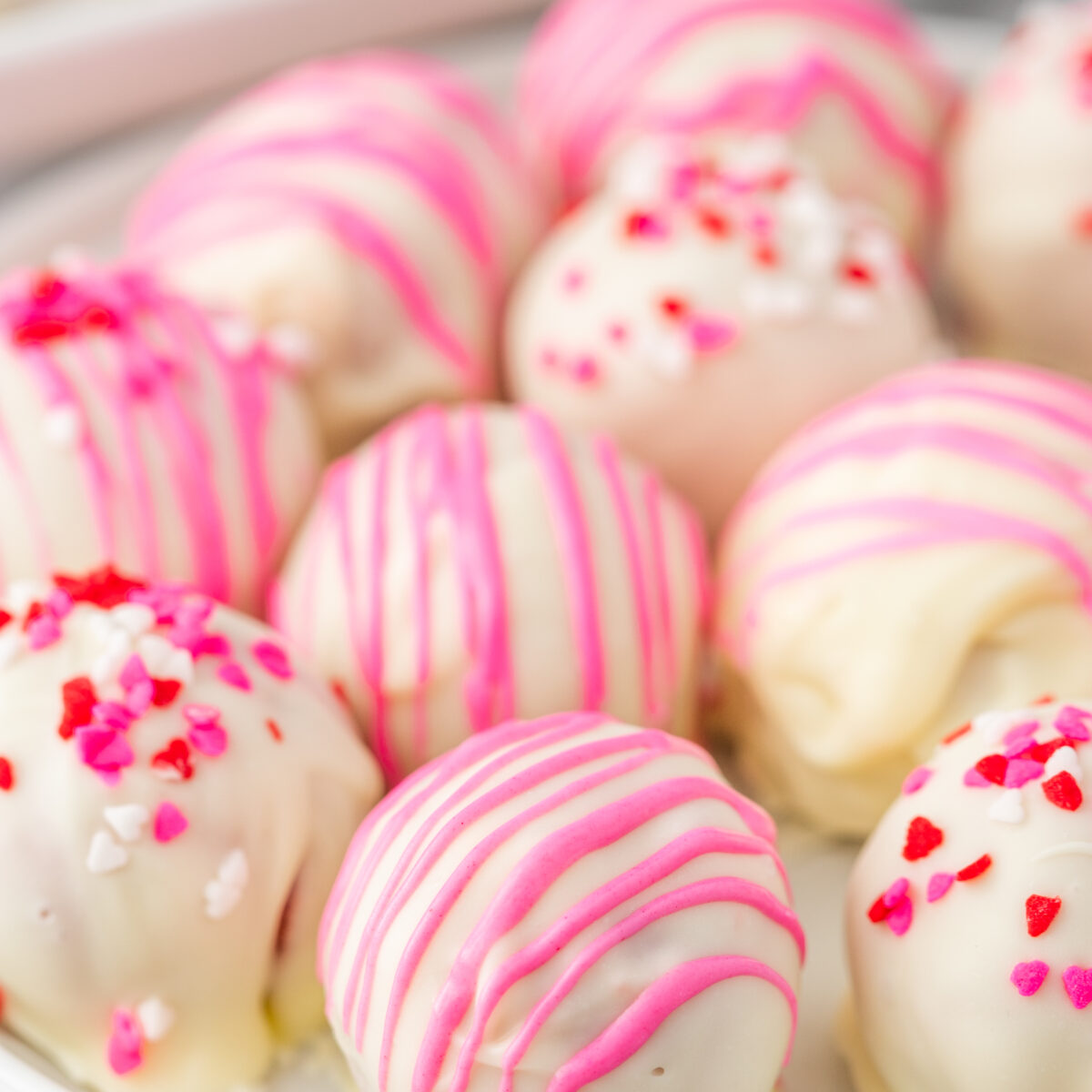 strawberry cake truffles on a white plate
