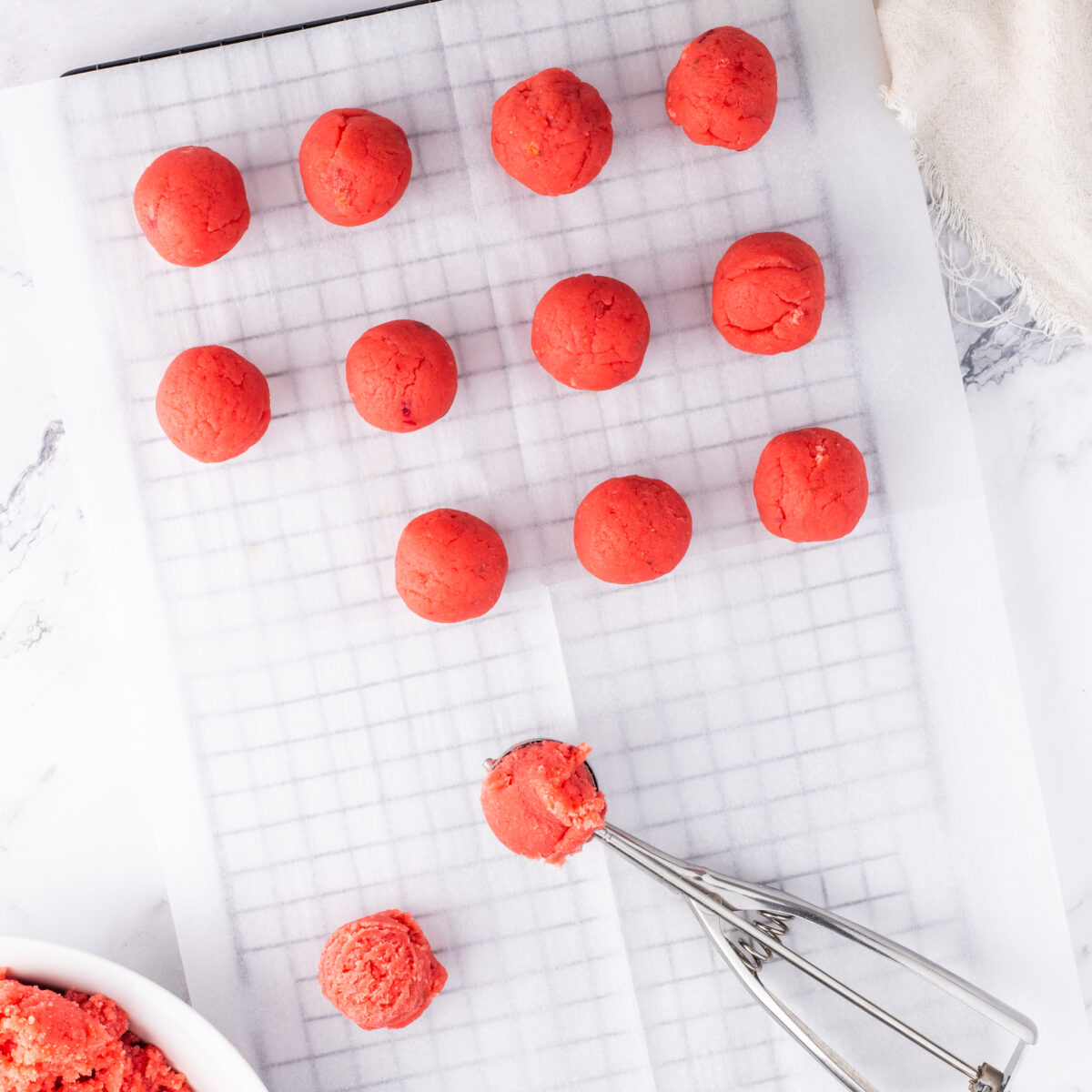 process shot showing strawberry truffles on a wire rack