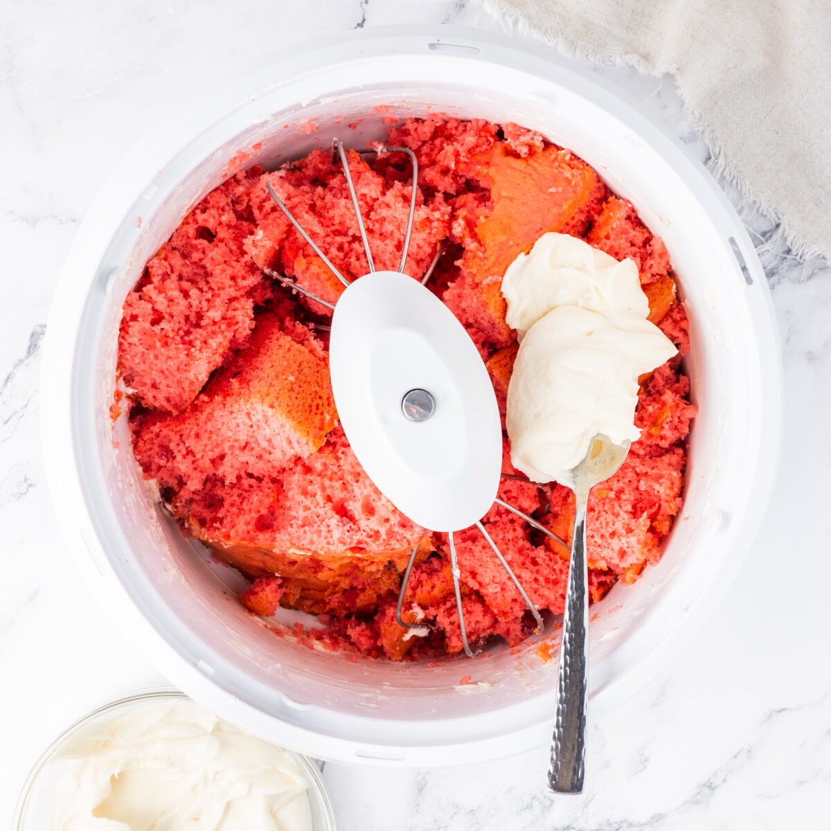 crumbled cake and frosting in a white bowl