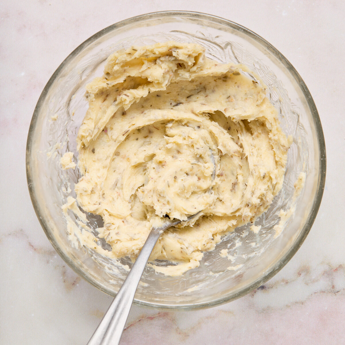 garlic butter spread in a clear glass bowl