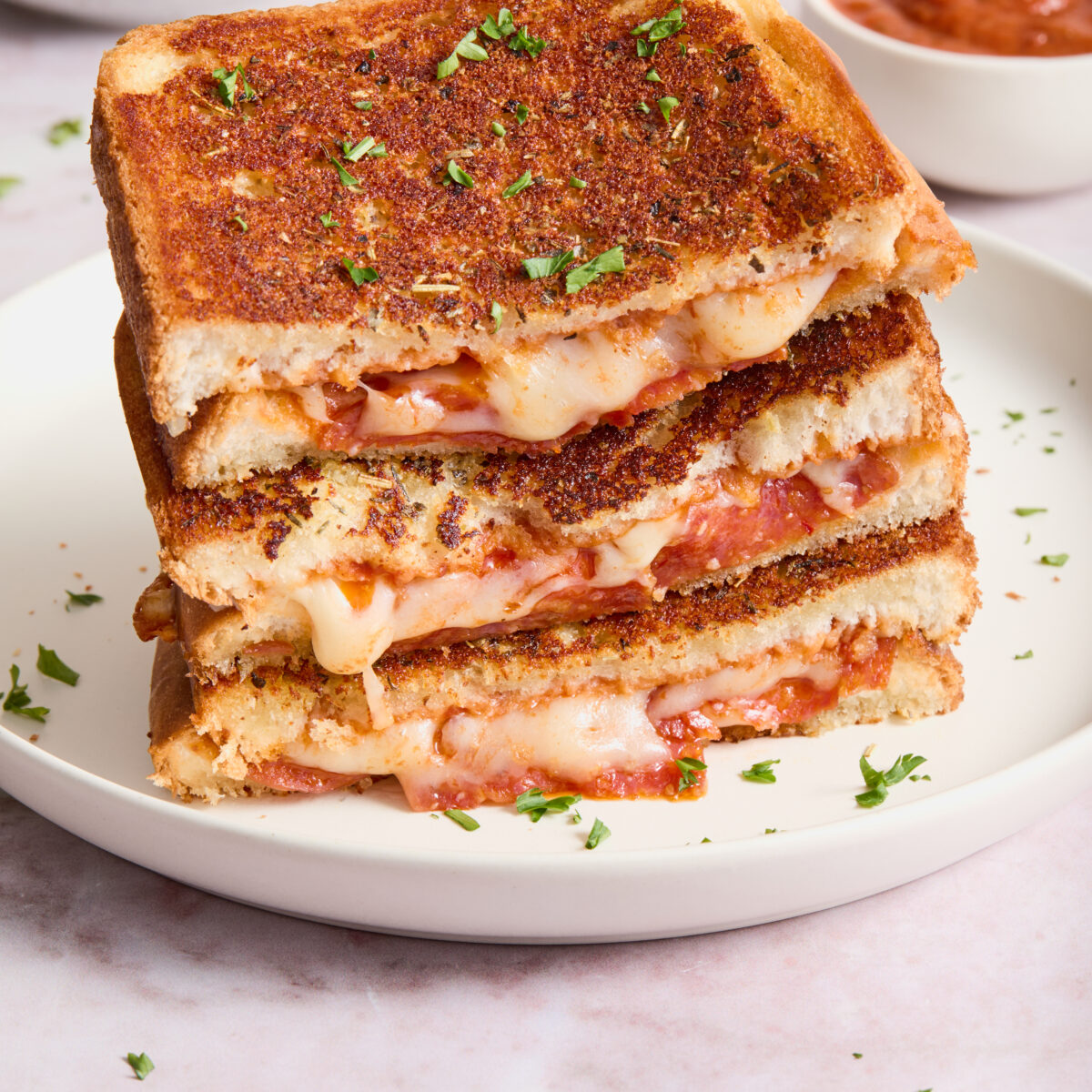 grilled cheese stacked on a white plate