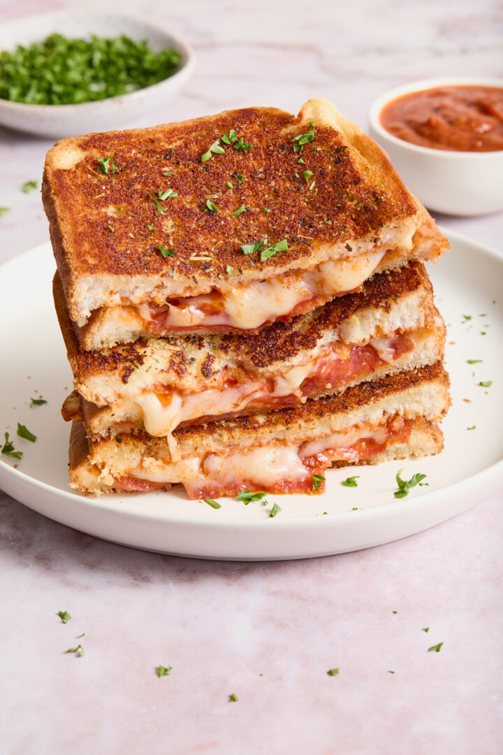 grilled cheese stacked on a white plate