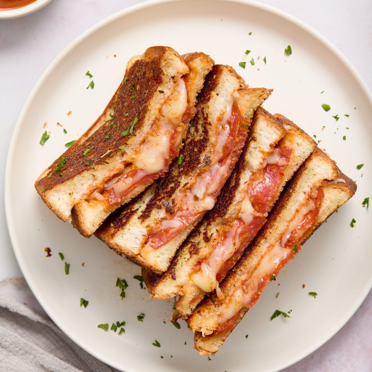 grilled cheese cut in half on a white plate