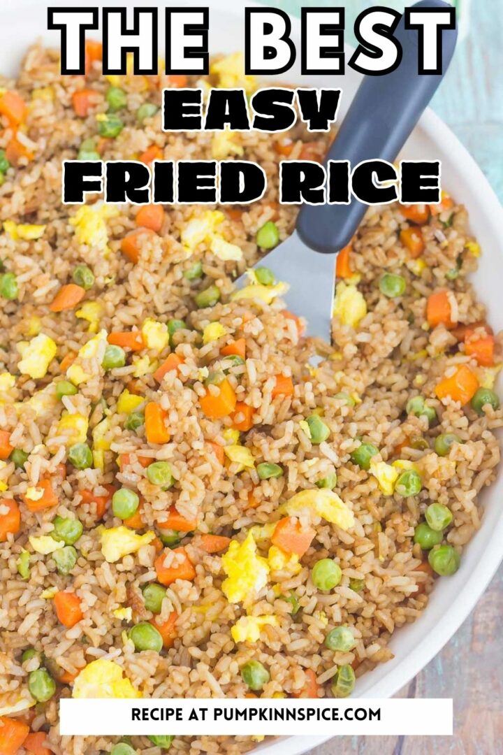 fried rice in a white pan with a spatula