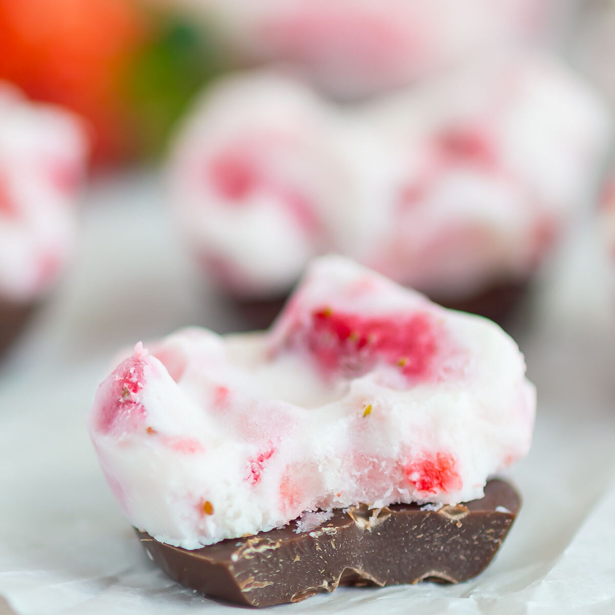 yogurt bite with a bite taken out on white parchment paper