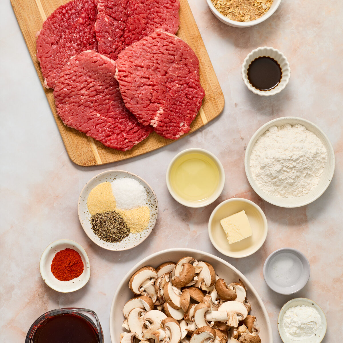 cube steak ingredients on a light pink surface