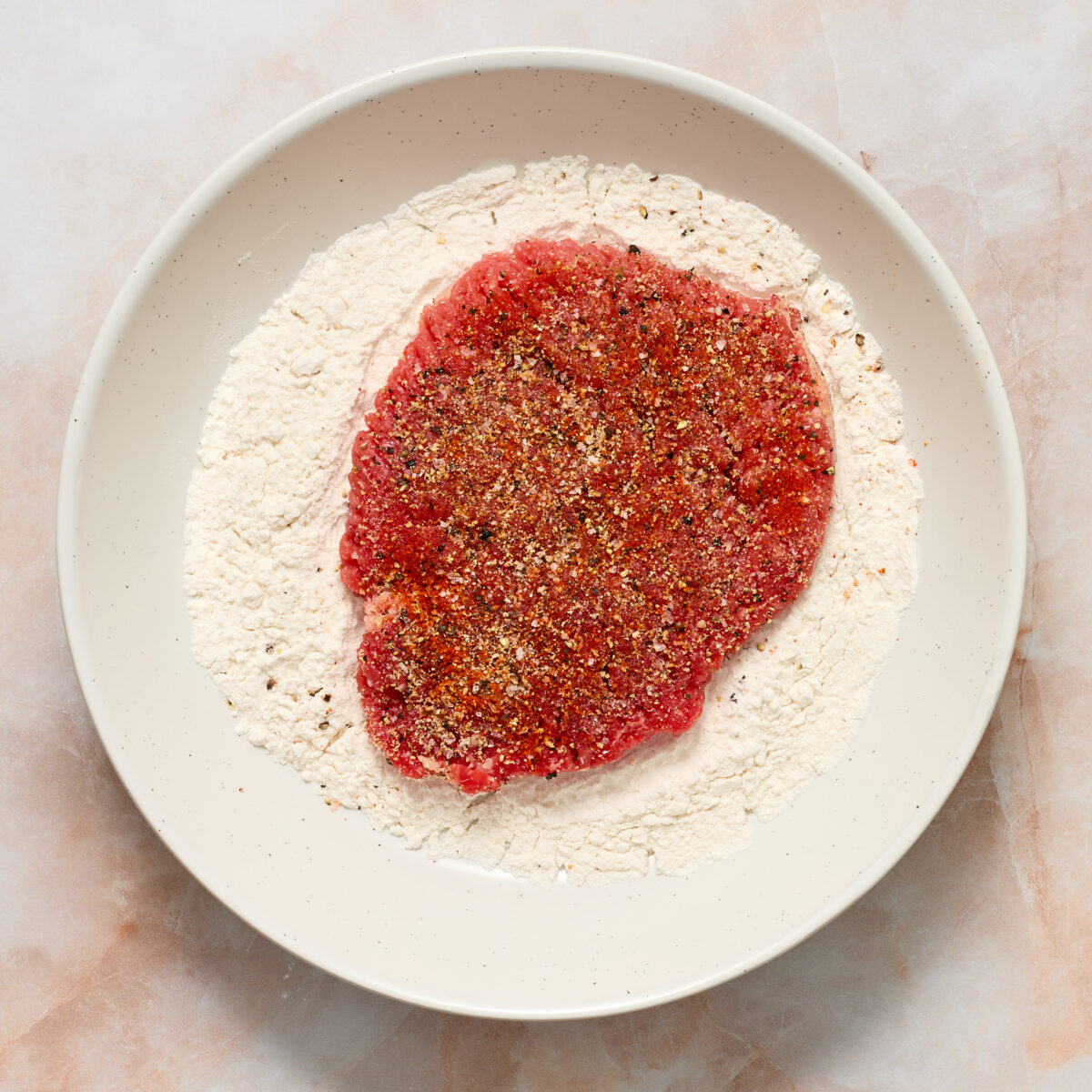 raw steak in flour