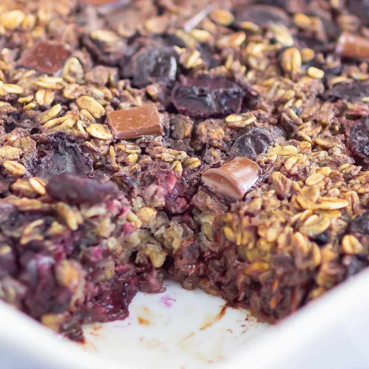 oatmeal bake in a white dish with a piece missing