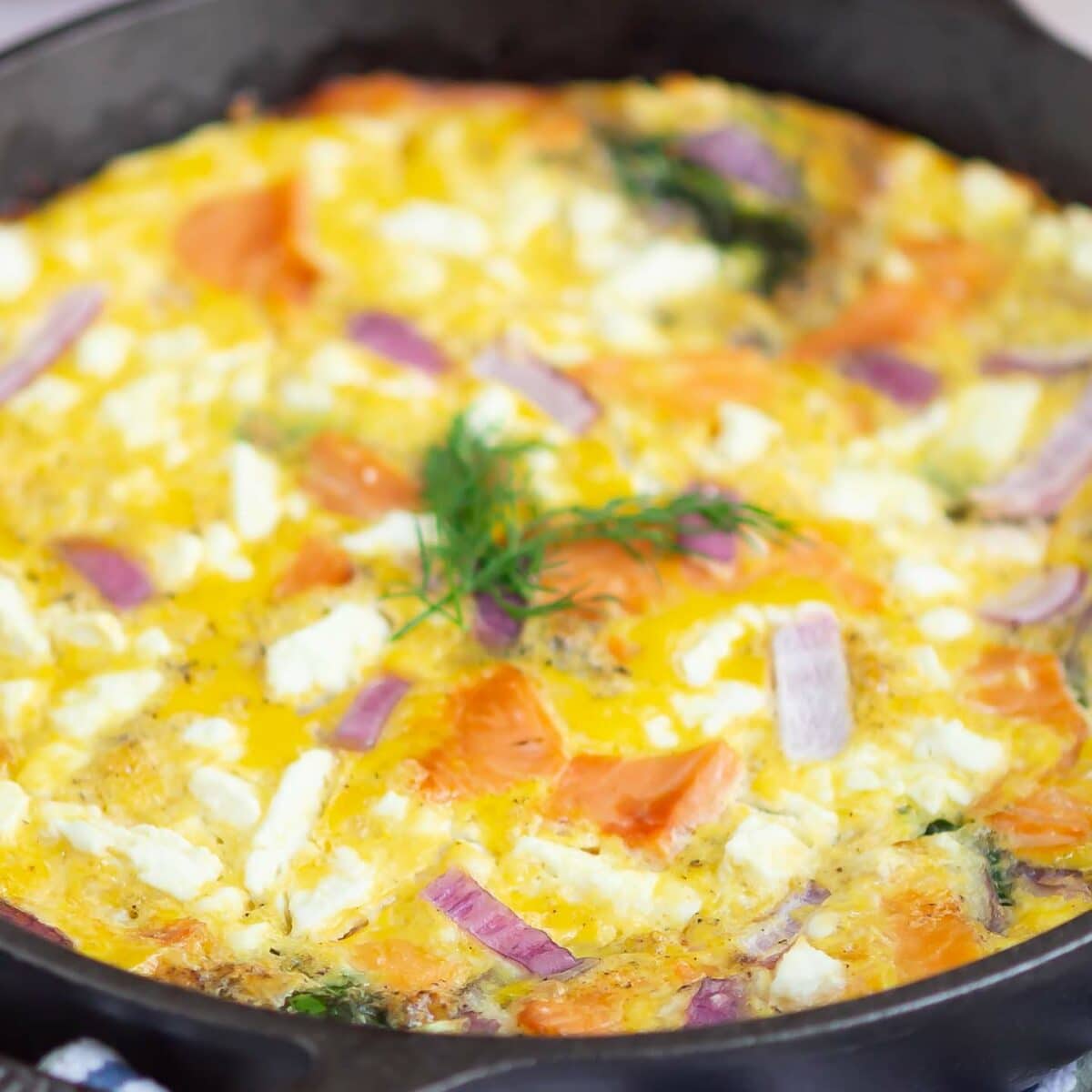 salmon frittata in a black skillet