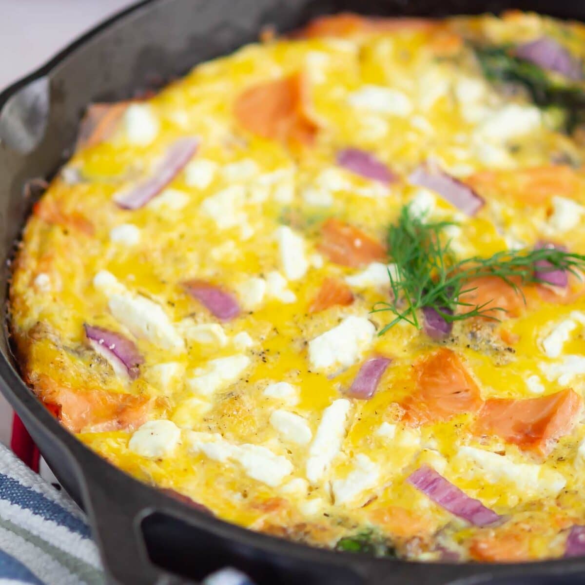 salmon frittata in a black skillet