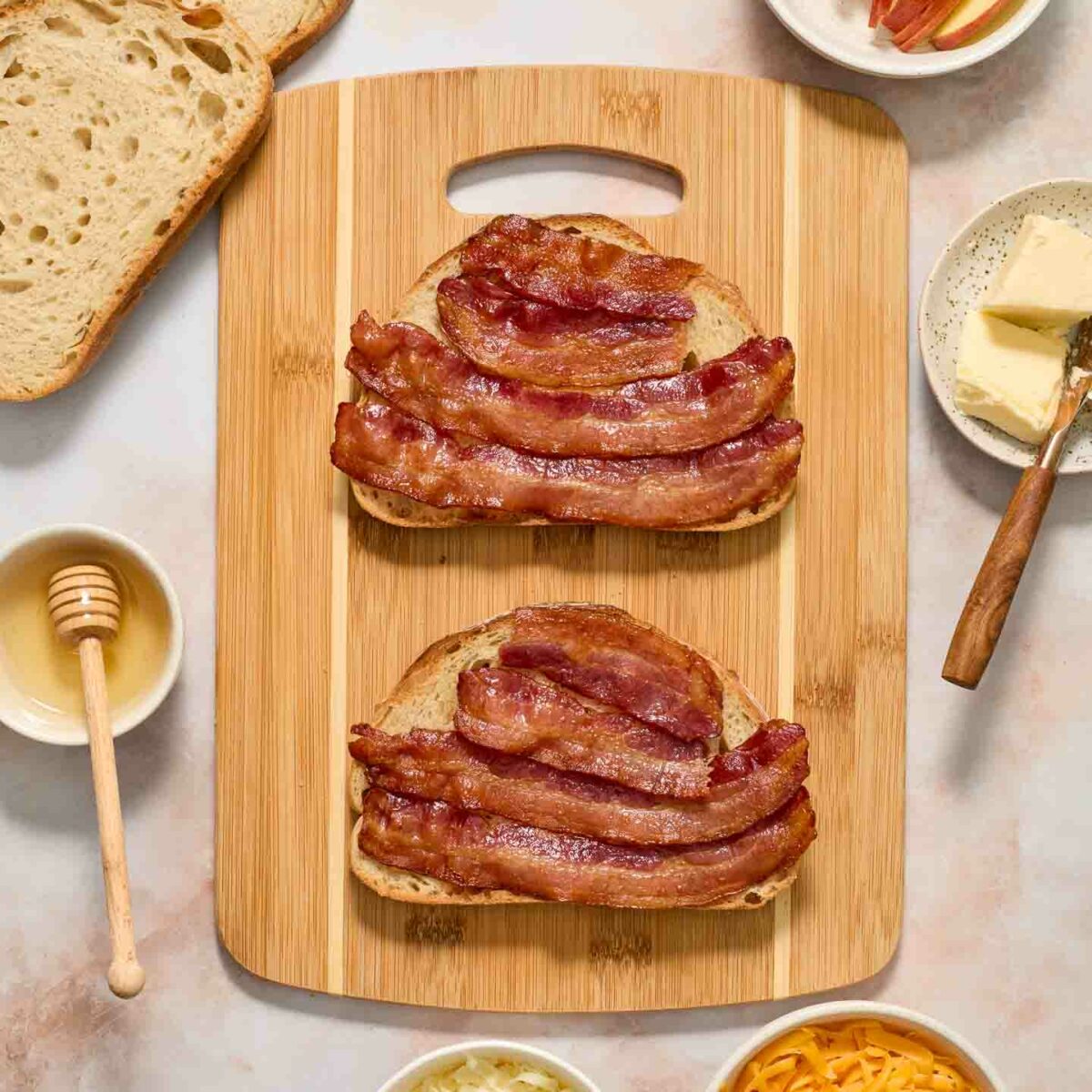 bread with bacon and honey on a cutting board