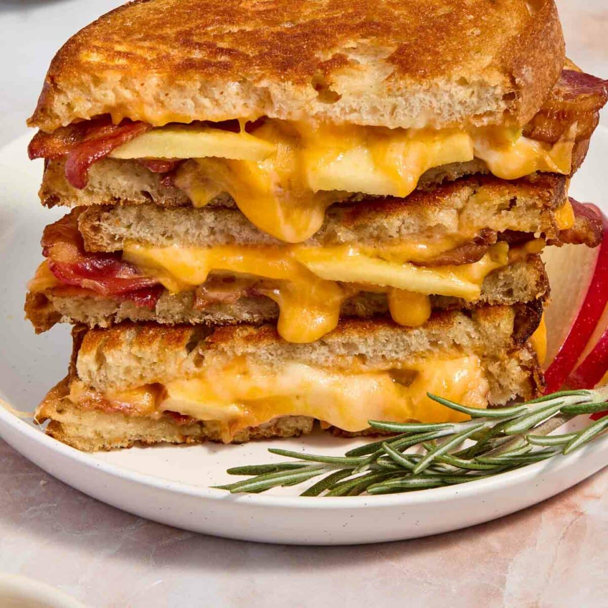 grilled cheese stacked on a white plate