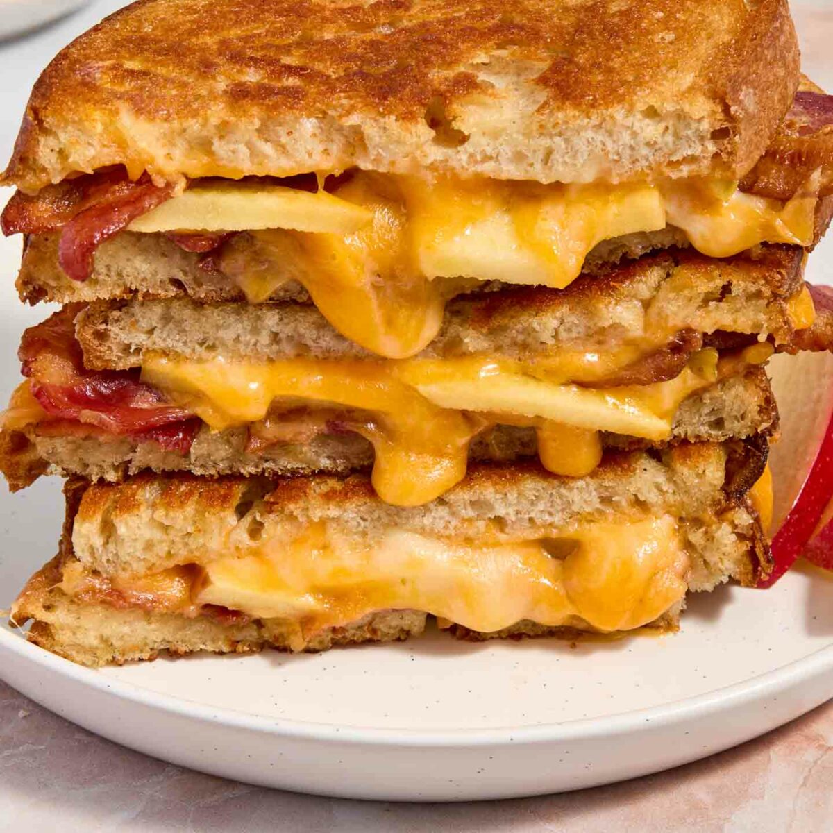 grilled cheese stacked on a white plate