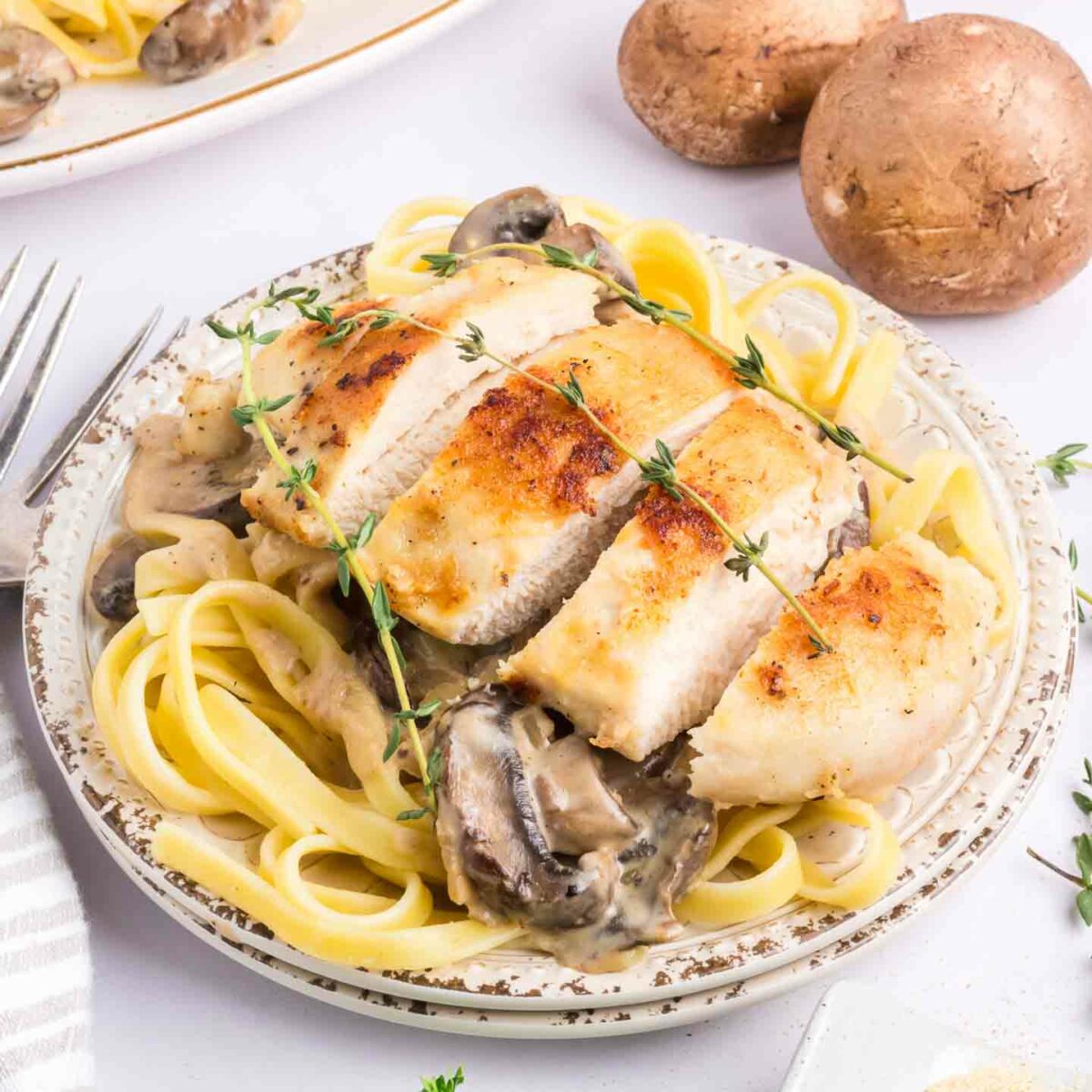 chicken marsala pasta on a white plate