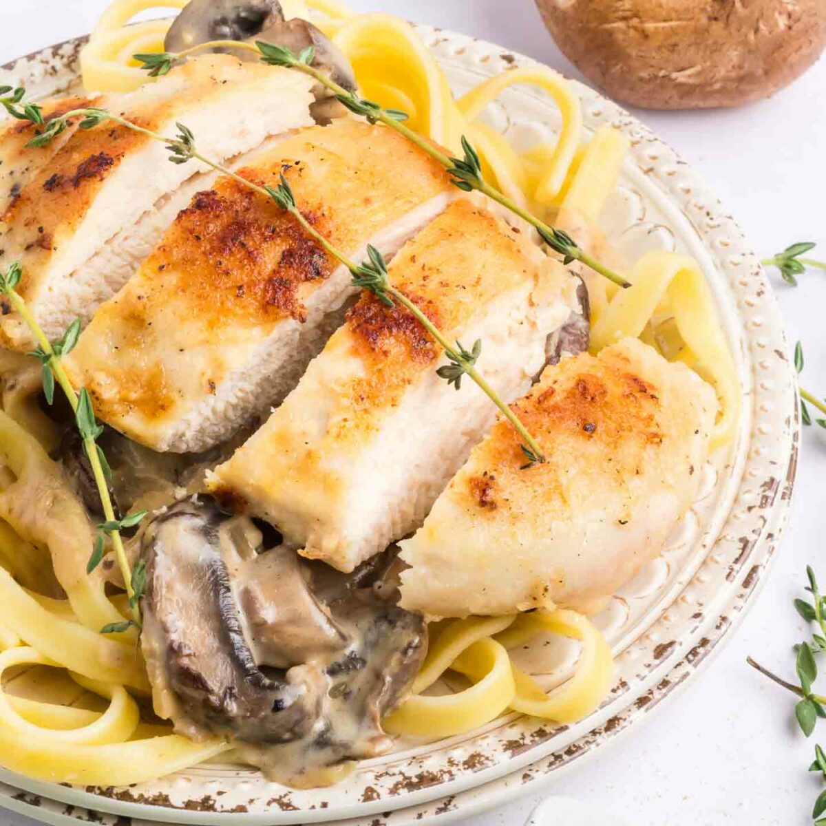 chicken marsala pasta on a white plate