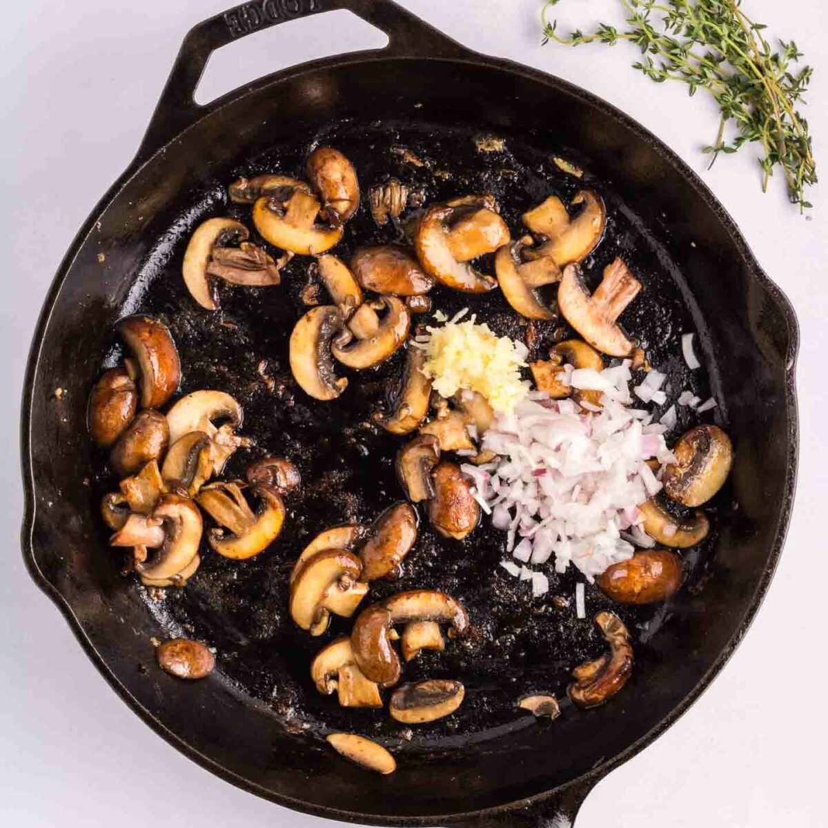 mushrooms, garlic, shallot in a black skillet