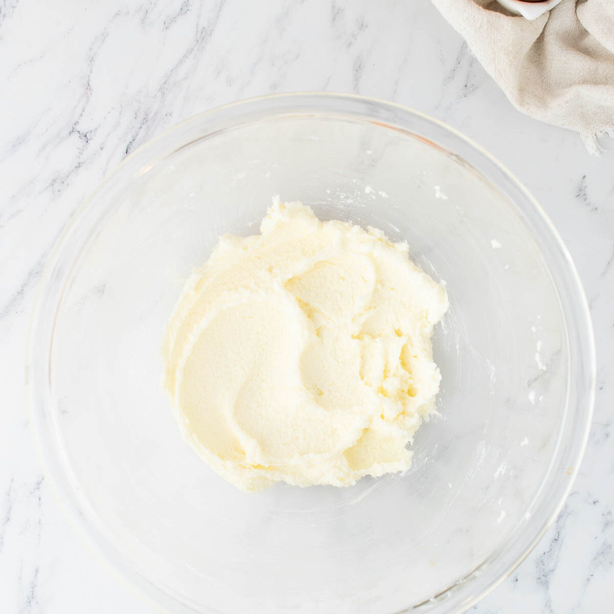 butter and sugar creamed in a glass bowl