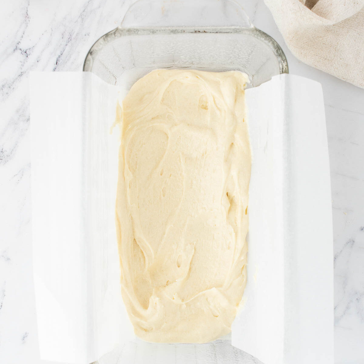batter spread out in a glass pan