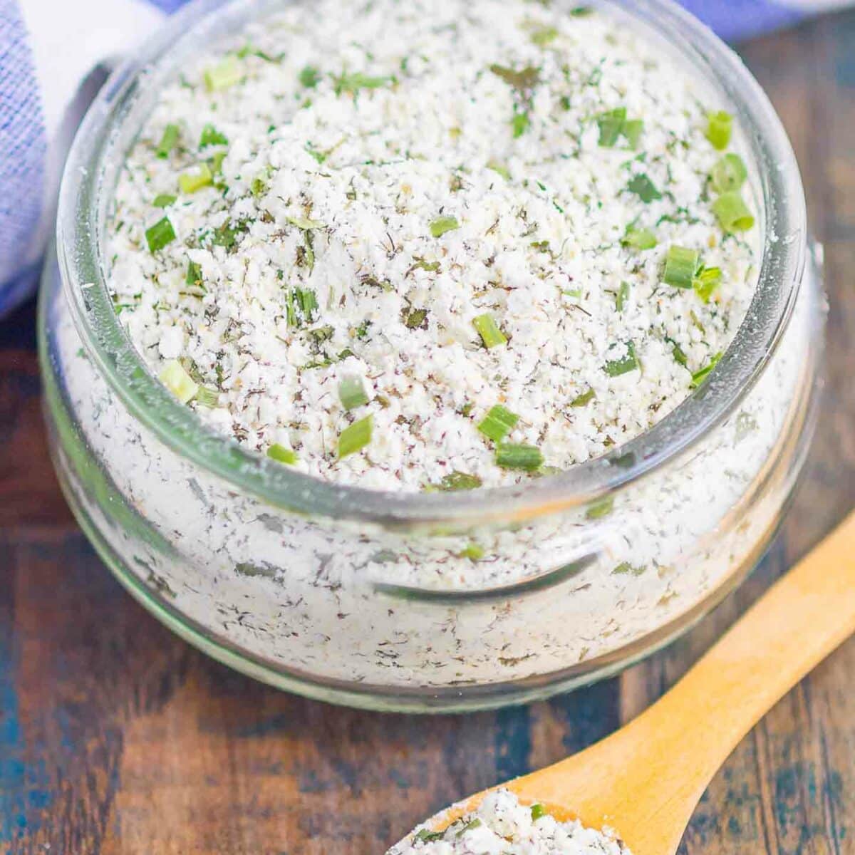 ranch seasoning mix in a glass jar with a wooden spoon