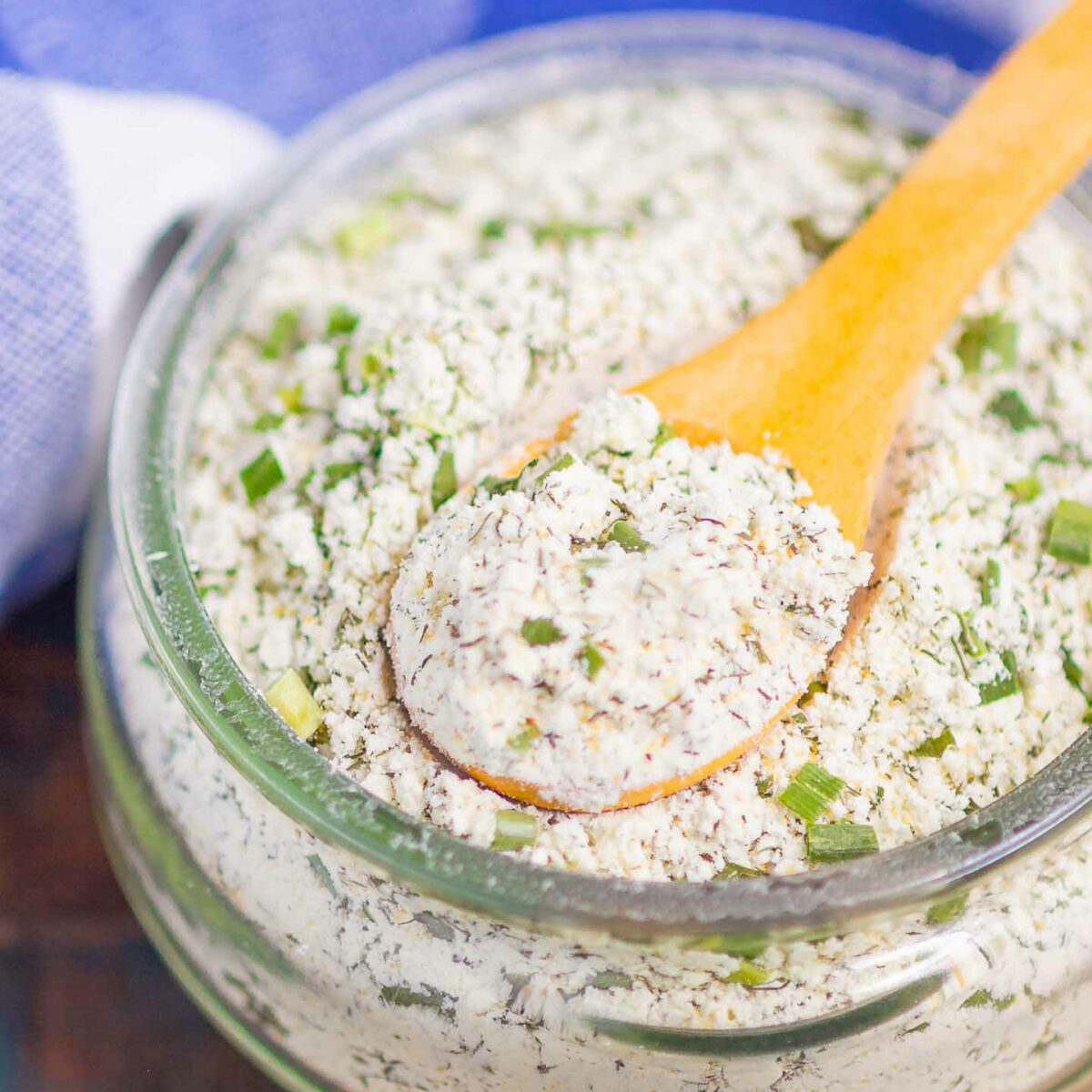 ranch seasoning mix in a glass jar with a wooden spoon