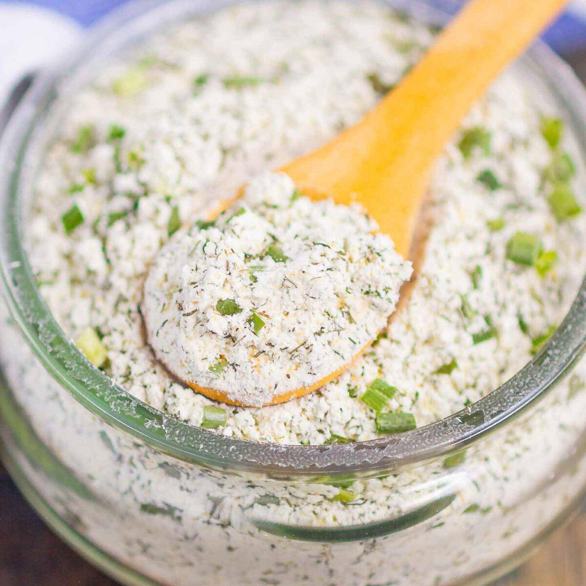 ranch seasoning mix in a glass jar with a wooden spoon