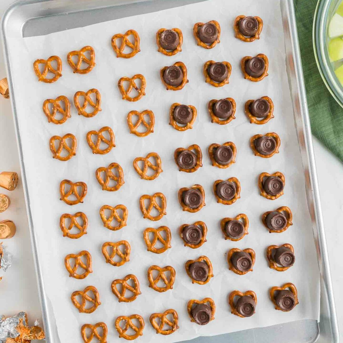 pretzels with rolos placed on top on a baking pan