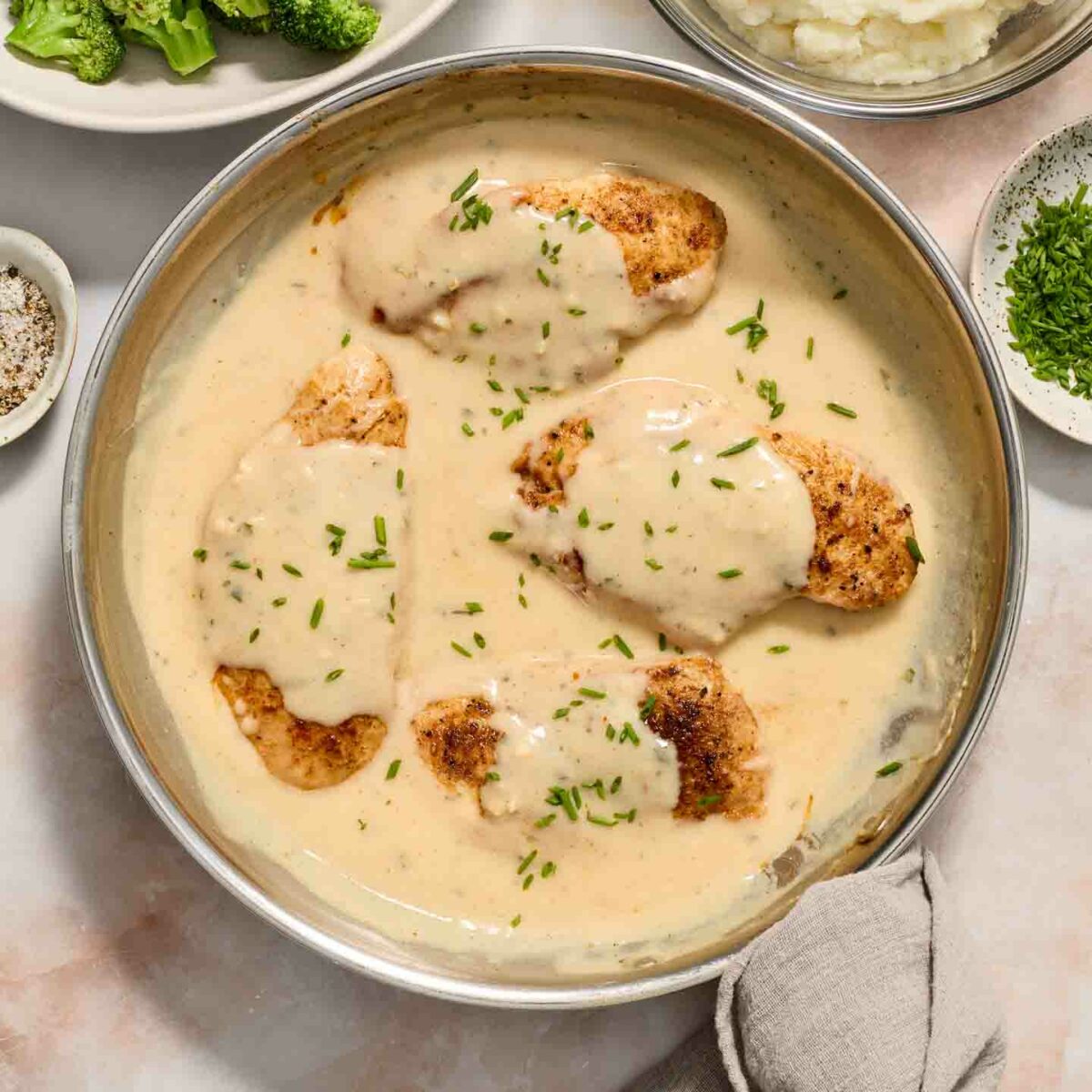 chicken in a skillet with cream sauce