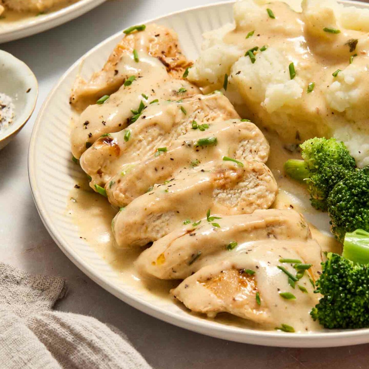 chicken with mashed potatoes and broccoli on a white plate