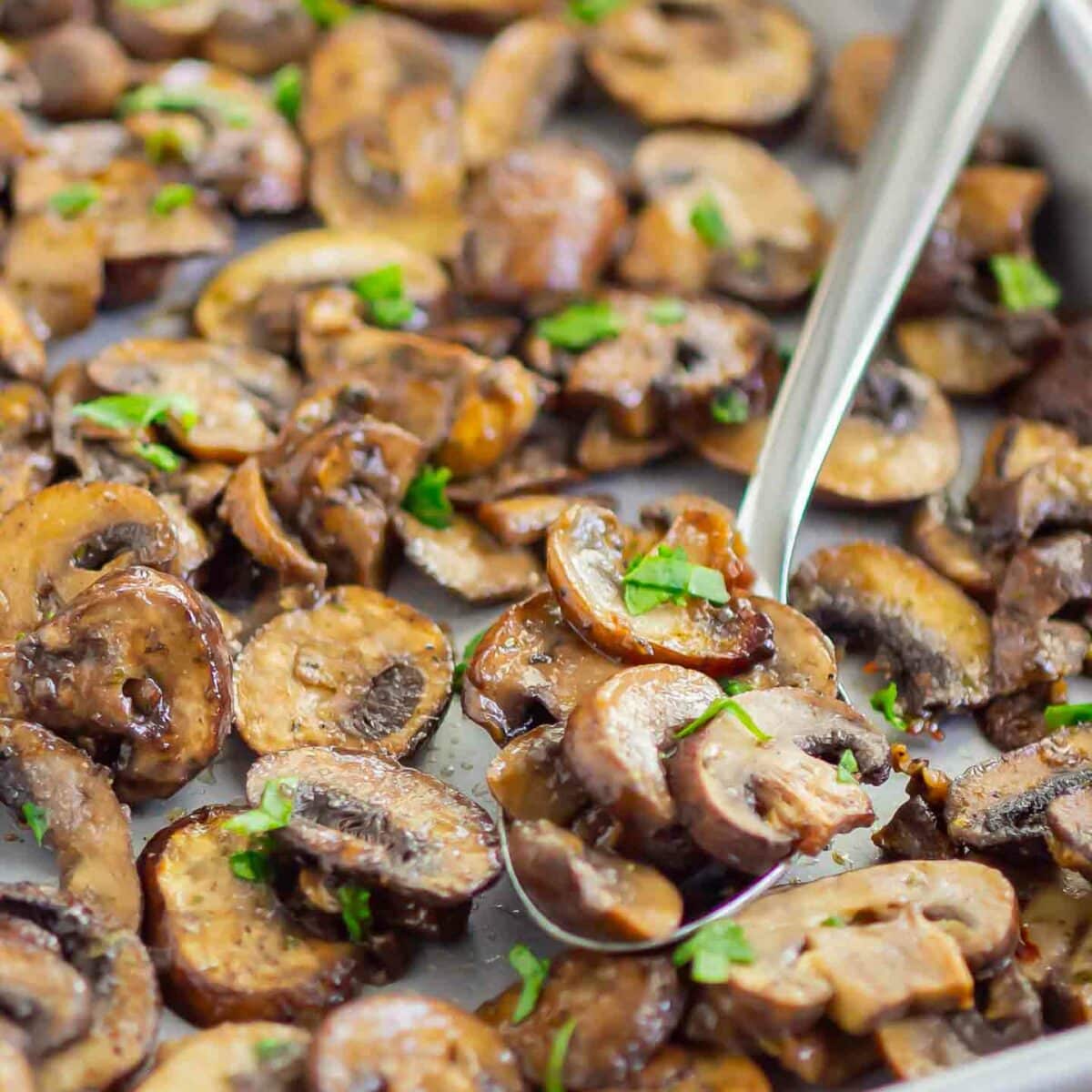 a spoonful of mushrooms on a sheet pan