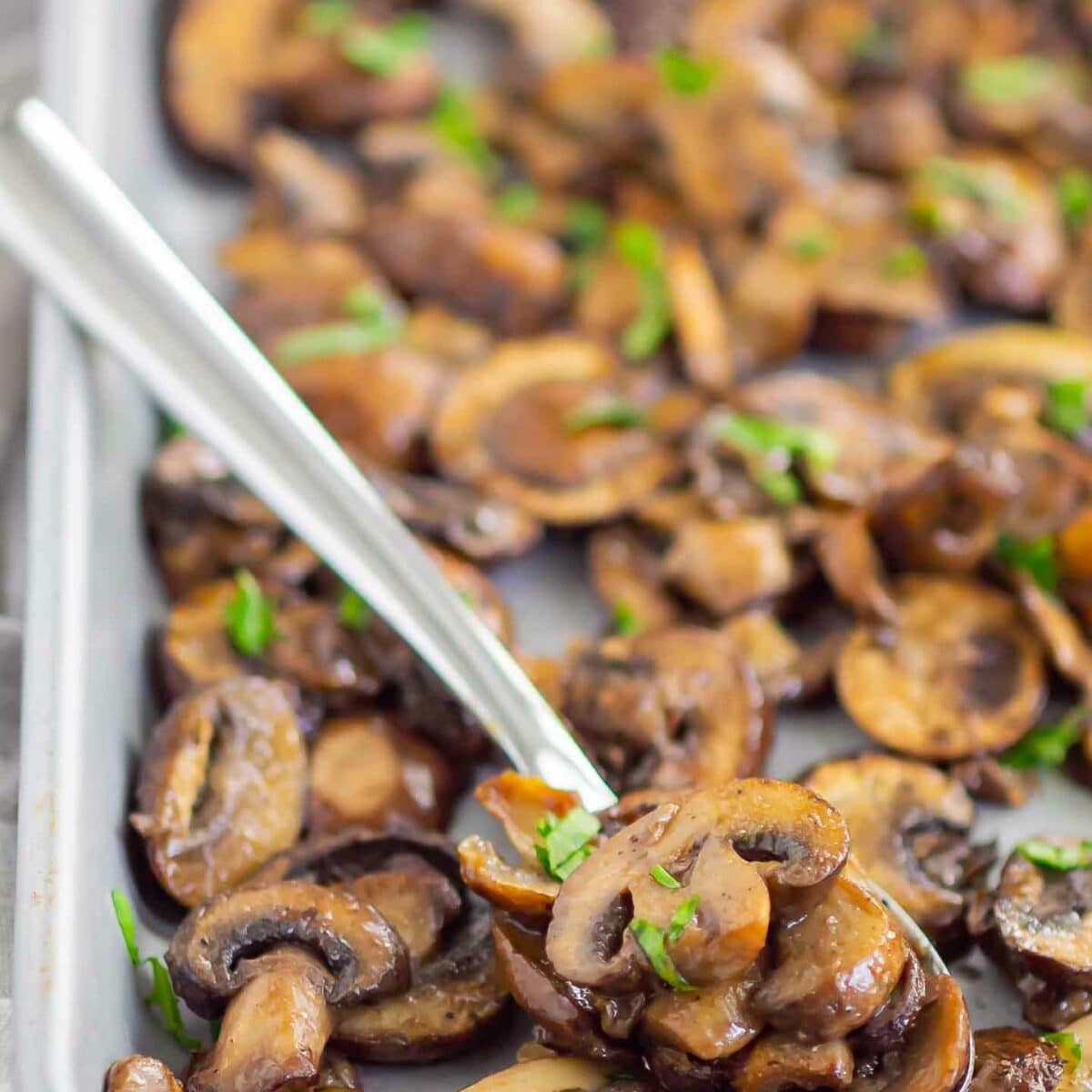 a spoonful of mushrooms on a sheet pan